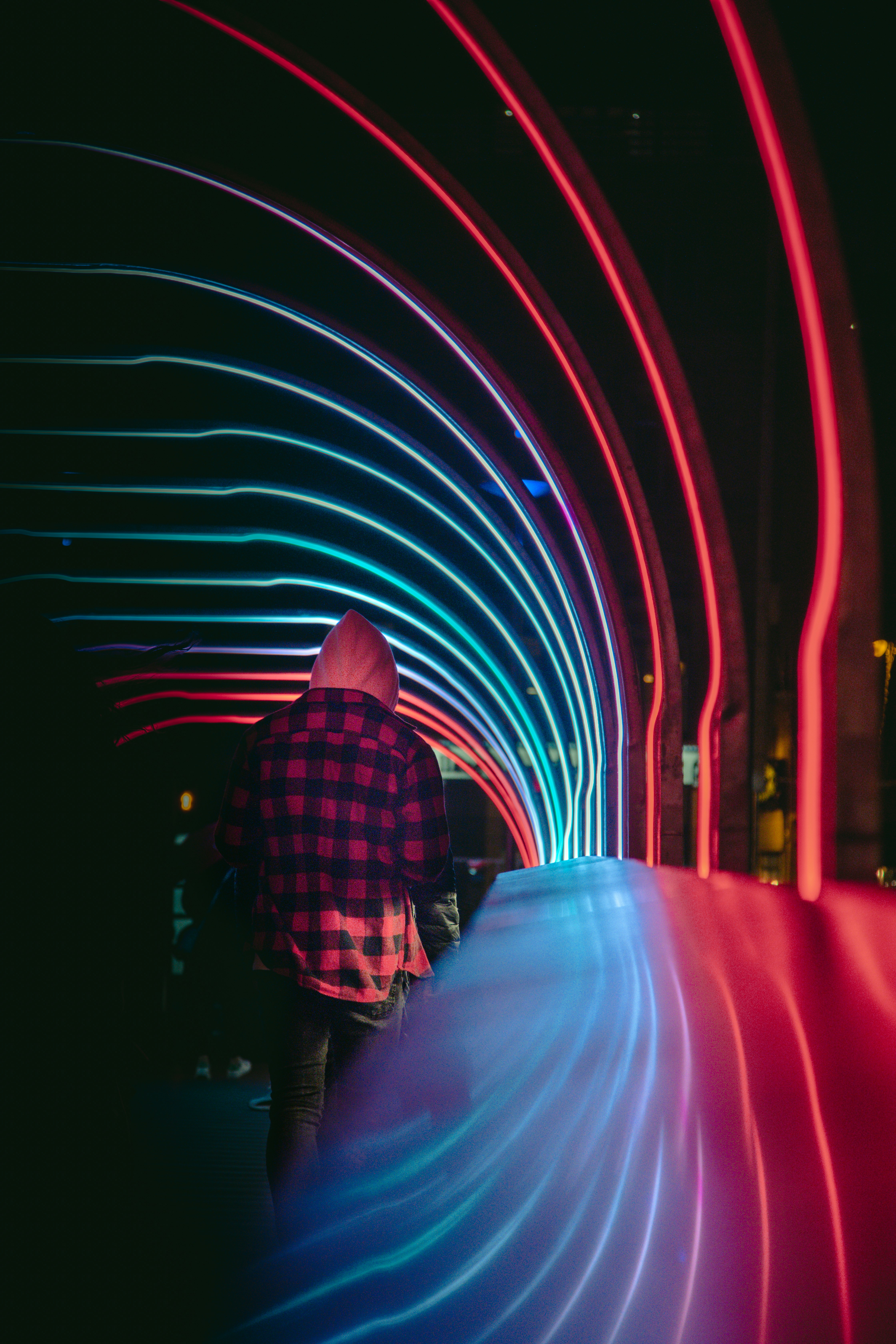 man in red and black plaid dress shirt standing near red lights